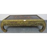 A vintage Chinese import opium table, the top with relief carving depicting sailing junks, the