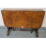 A Victorian walnut Sutherland table, with marquetry inlay, on turned supports with ceramic