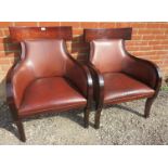 A pair of contemporary richly coloured fruitwood armchairs in the French Empire taste, upholstered