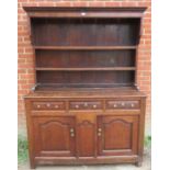 A Georgian oak high back dresser, with plate rack shelving over base containing two short drawers