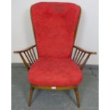 A mid-century Ercol elm ?Evergreen? high back armchair in golden dawn finish, with loose cushions
