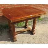 An Art Deco oak draw leaf dining table of small proportions, on octagonal and ball turned supports
