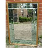 A contemporary gilt framed sectioned rectangular wall mirror, comprising 25 bevelled mirror