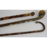 A bulbous headed chestnut walking stick with souvenir plaques attached, a turned head walking cane