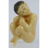 A Japanese erotic carved ivory Netsuke, early 20th century of a female nude. Height: 4.8cm. Signed