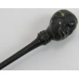 A cold painted bronze pipe tamper with figural African head finial