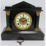 An antique American striking mantel clock with blackened steel case and Ansonia movement. Key and