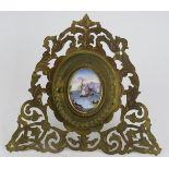 A mid 19th century folding picture frame in gilt metal with porcelain oval cartouche. Signed for ma