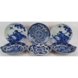 Six antique Japanese porcelain chargers decorated in blue and white. Largest 32cm diameter (6).