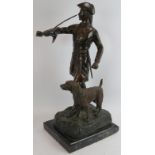 A large bronze of a French huntsman and hound mounted on a black marble plinth, stamped P.J. Mene.