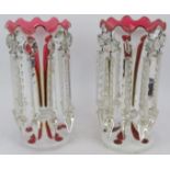 A pair of Victorian pink and white flash cut table lustres with cut glass drops. Height 26cm. (