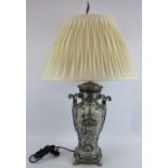 A Chinoiserie porcelain lamp with ornate pewter mounts and a cream pleated shade. Overall height