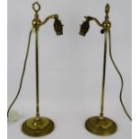 A pair of brass rise and fall desk lamps by Christopher Wray. Height 54cm. Condition report: