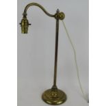 An early antique brass rise and fall desk lamp with filled lead base. Height 45cm. Condition report: