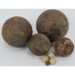 Four antique iron cannon balls of various size and four lead musket balls. Largest 10cm diameter.