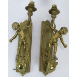 A pair of brass Rococo style cherub wall light sconces. Height 35cm. Condition report: Untested.