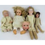 Four antique dolls, one with jointed leather body, one by Heubach and an additional Bisque head