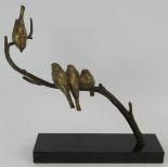 An Art Deco style cold painted sculpture of birds on a branch mounted on a black marble plinth,