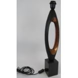 A modernistic copper table lamp of elongated form mounted on a black marble base. Height 63cm.