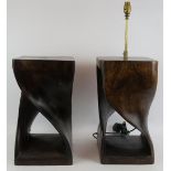 A pair of large carved wood lamp bases, one fully fitted and with shade, the other is base only.