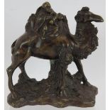 A small 20th century bronze of a Chinese traveller riding a Bactrian camel. Height 17cm. Condition