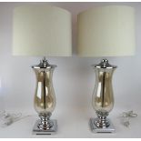 A large pair of contemporary chrome and smoked glass table lamps of baluster form with natural