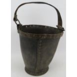 A Georgian copper bound leather fire bucket with rivetted base and join. Height 30cm + handle.