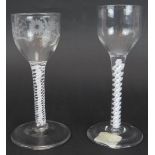 Two 18th century opaque twist drinking glasses, one with an engraved bowl, both with plain stems and