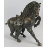 A bronze figure of a Tang style Chinese horse about to rear. Height 34cm. Condition report: Some