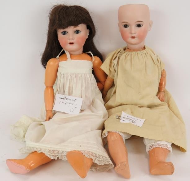 Two antique German Bisque headed dolls by C.M. Bergmann both marked, one missing hair. Both 60cm. (