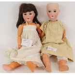 Two antique German Bisque headed dolls by C.M. Bergmann both marked, one missing hair. Both 60cm. (