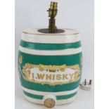 An antique hand decorated porcelain Irish Whiskey barrel later converted into a lamp. Height 38cm.