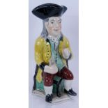 An early Staffordshire Pottery toby jug decorated in polychrome colours. Height 28cm. Condition