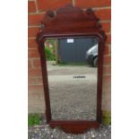 A Georgian mahogany rectangular wall mirror in a shaped and scrolled surround. Condition report: