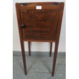 A Georgian mahogany bedside cabinet with ¾ gallery, on tapering square supports. Condition report: