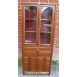 A 20th century Chinese hardwood display cabinet, the glazed upper section housing two shelves, the