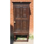 A 19th century oak cabinet on stand in a 17th century taste, the relief carved panels depicting