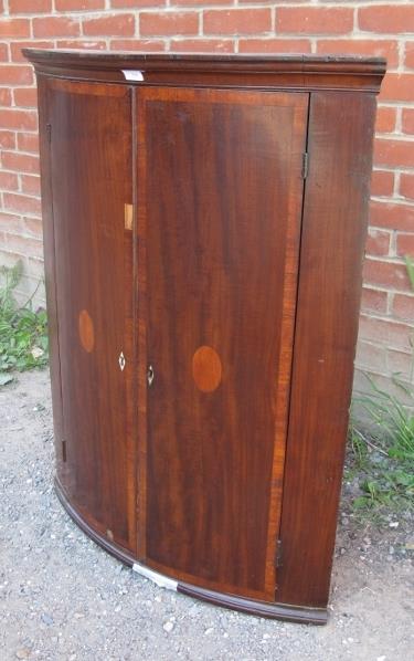 A George III mahogany bow fronted corner cupboard, with crossbanded inlay, housing four fitted - Image 2 of 3