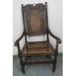 A 17th century Carolean oak hall chair with bergere back and seat panels, featuring barley twist
