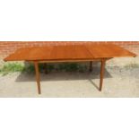 A mid-century teak extending dining table by McIntosh with double butterfly leaf extensions, on
