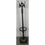 An Edwardian mahogany coat stand, the rotating top with four lion mask coat hooks, over an