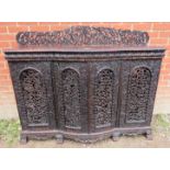 A 19th century hardwood Anglo Indian Colonial side cabinet, with ornately carved and pierced gallery