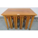 A set of mid-century teak nesting tables in the manner of Poul Hundevad, comprising a rectangular
