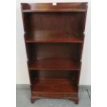 An Edwardian Georgian Revival mahogany waterfall open bookcase of four shelves, having one long cock