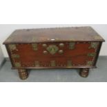 A 19th century hardwood Zanzibar chest, with ornate brass mounts depicting fish and foliate motifs