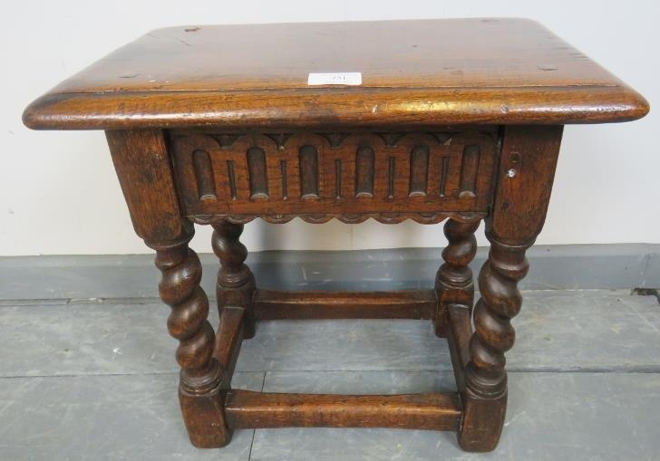A 19th century oak joint stool in a 17th century taste, with chisel carved frieze, on barley twist