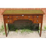 An Edwardian mahogany writing desk, with inset green leather top, housing a configuration of one