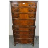 A diminutive reproduction Georgian style walnut chest on chest, having eight graduated drawers