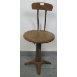 An early 20th century height adjustable machinist?s stool by Singer, with oak seat and plywood