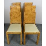A set of four Art Deco birds eye maple dining chairs with cream vinyl seats, on square supports.